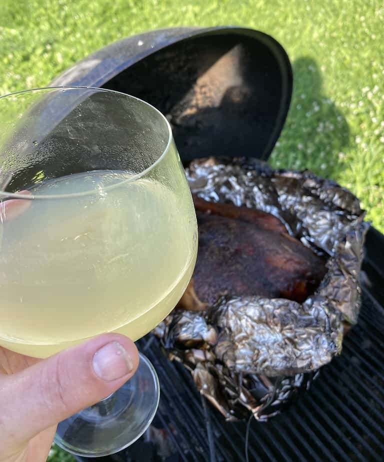 Lemon drop cocktail and a smoked chicken on a grill